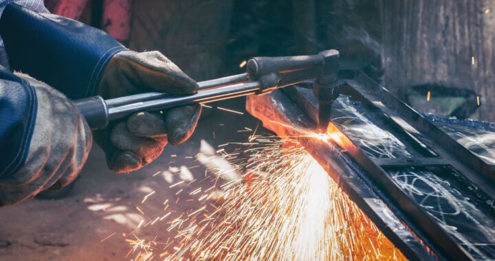Man cutting stainless steel plate