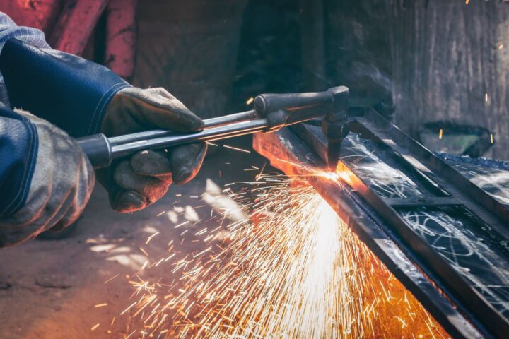 Man cutting stainless steel plate