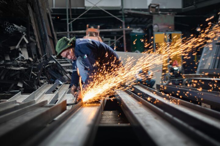 Man cutting stainless steel. Fabrication Stainless Steel